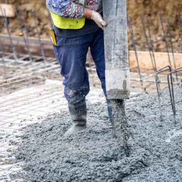 Pouring concrete in house building construction site